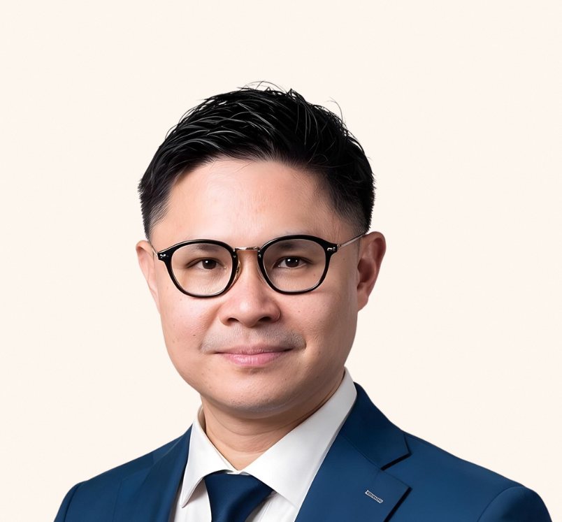 Minister of State Foo Cexiang in a navy blue blazer, smiling at the camera.